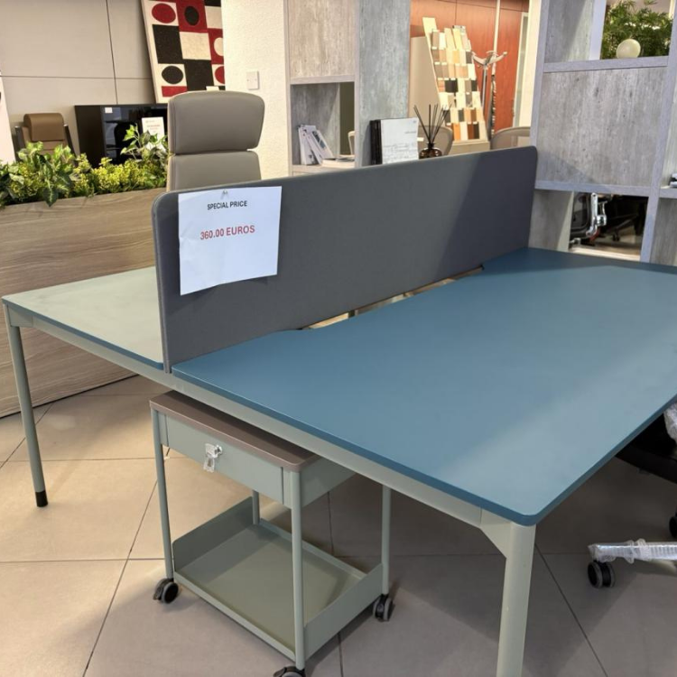A teal and gray office desk with a privacy screen and a rolling cart underneath is on display.