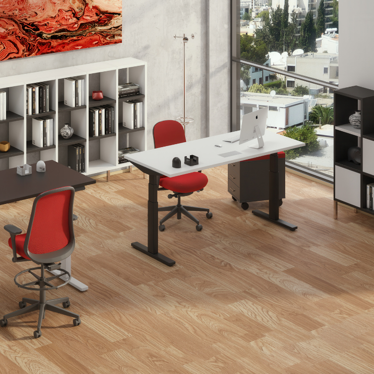 A modern office space featuring two desks, red swivel chairs, bookshelves, and a large window overlooking a city.