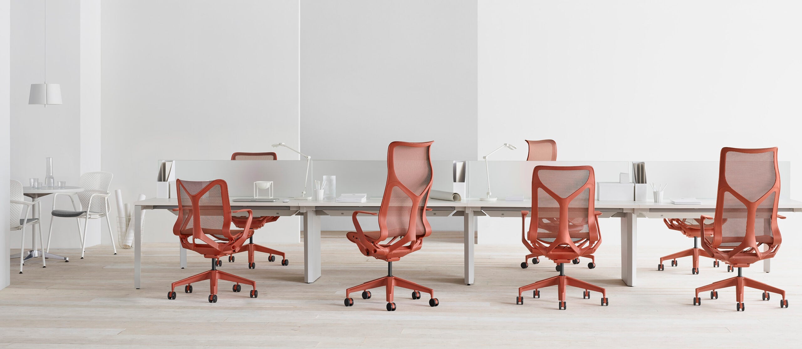 Herman Miller Cosm chairs around white office desks